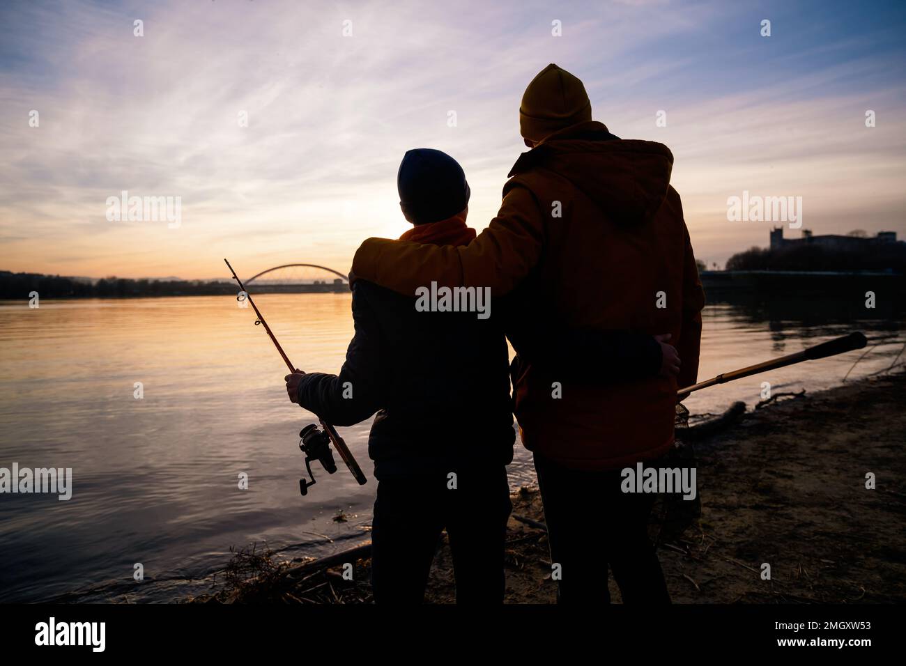 Silhouette father son fishing sunset hi-res stock photography and ...