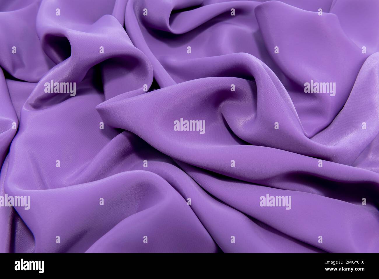 The texture of a smooth elegant fabric of silk, satin blue, purple with ...