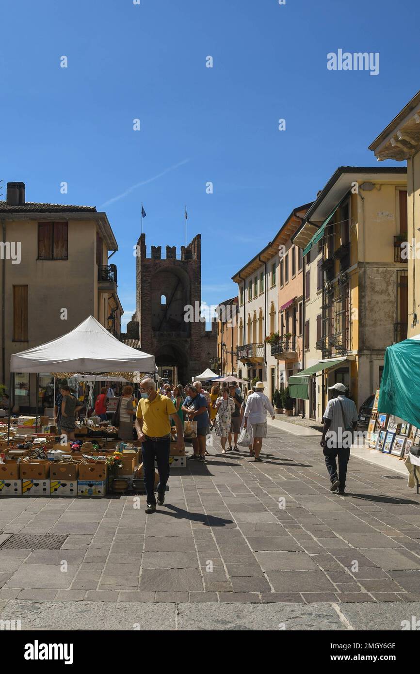Antiques market in the main street of Soave with Porta Verona city gate in the background in summer, Verona, Veneto, Italy Stock Photo