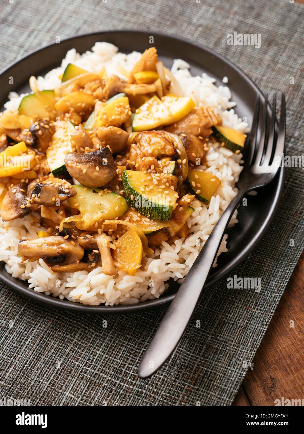 Zucchini, Mushrooms and  Vegan Chickun on rice. Stock Photo