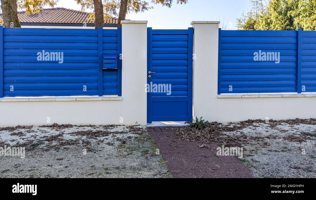 classic pedestrian blue door metal home gate at entrance of house portal garden Aluminum Stock Photo