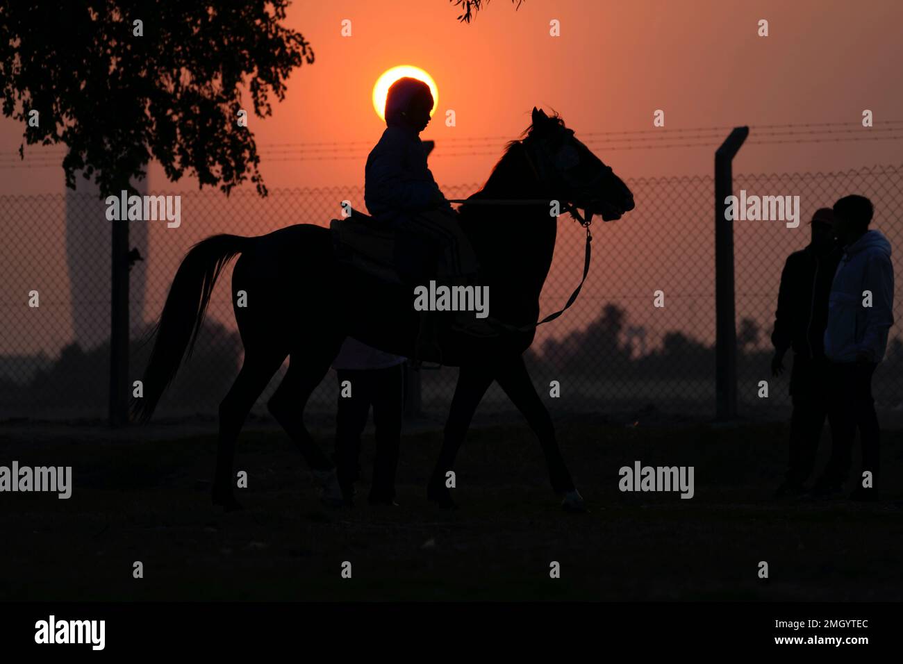 A young man rides his horse at sunset near the bank of the Tigris River