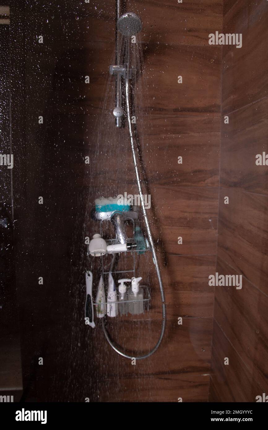 photo water pouring through the shower in the shower cabin view through ...