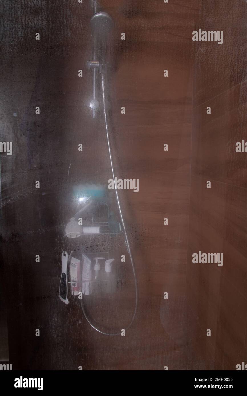 photo view of the shower cabin through the fogged glass door Stock