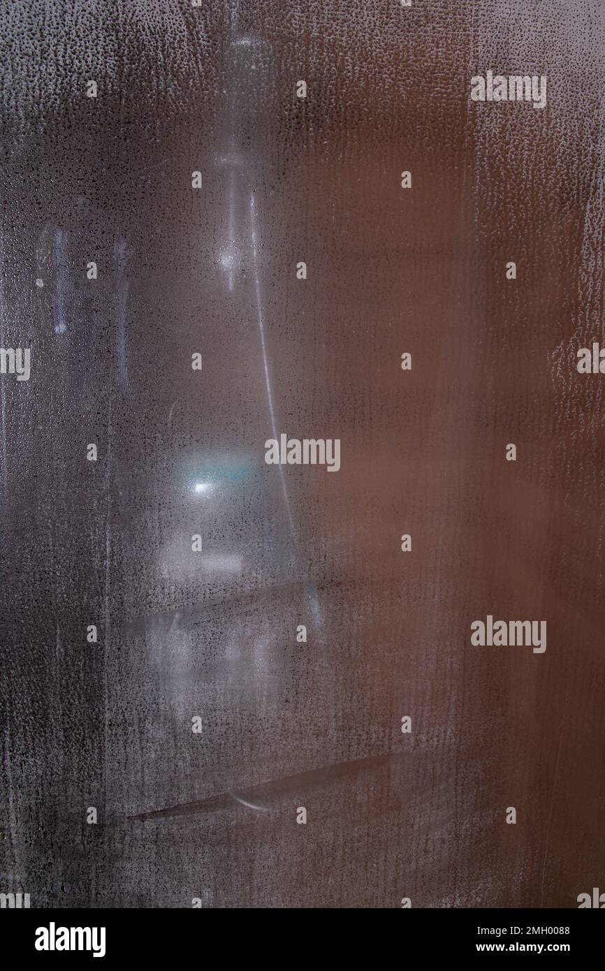 photo shower enclosure with shower accessories through fogged glass