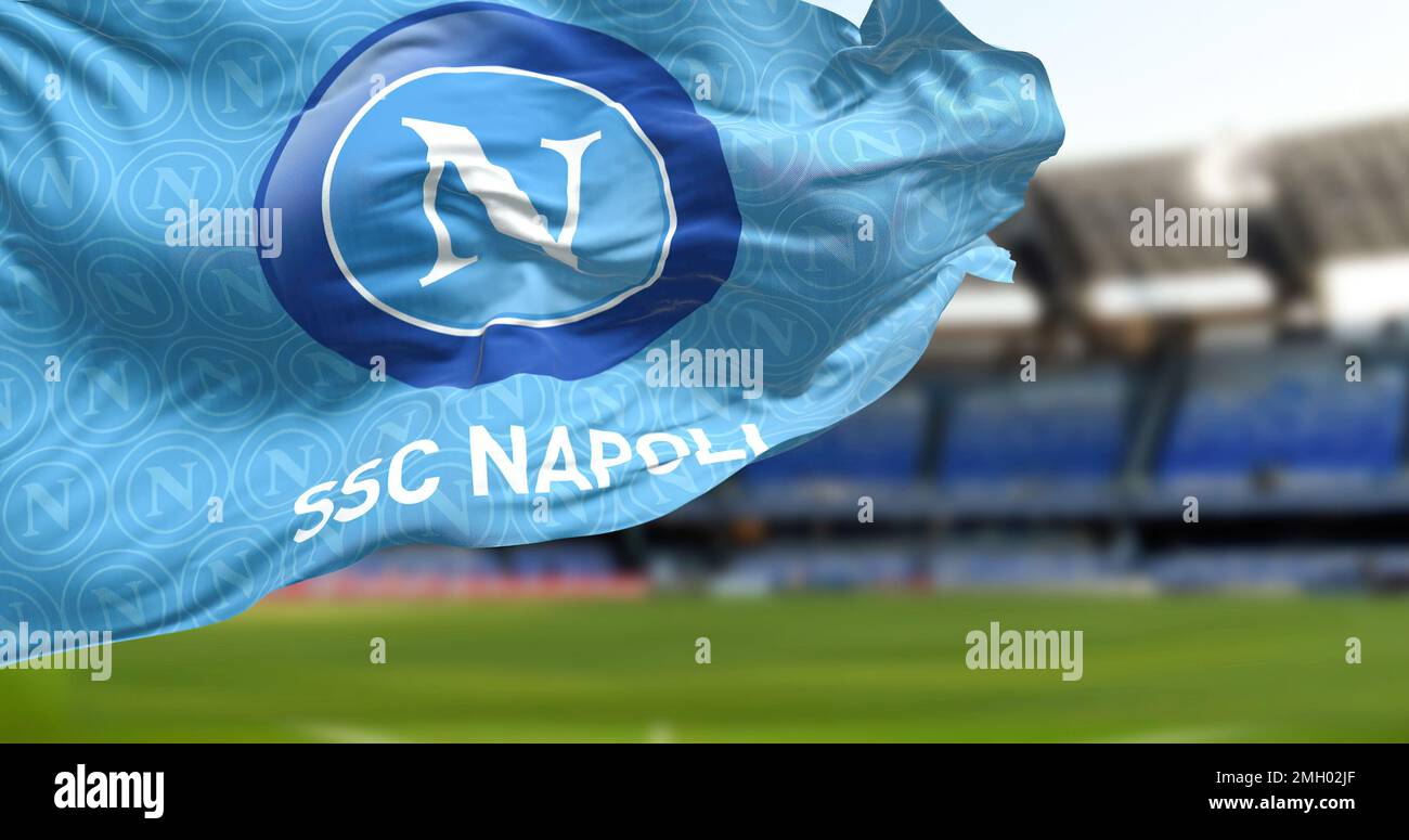 Naples, IT, Jan 2023: The flag of SSC Napoli waving with the Diego Armando Maradona Stadium blurred in the background. Italian football team based in Stock Photo