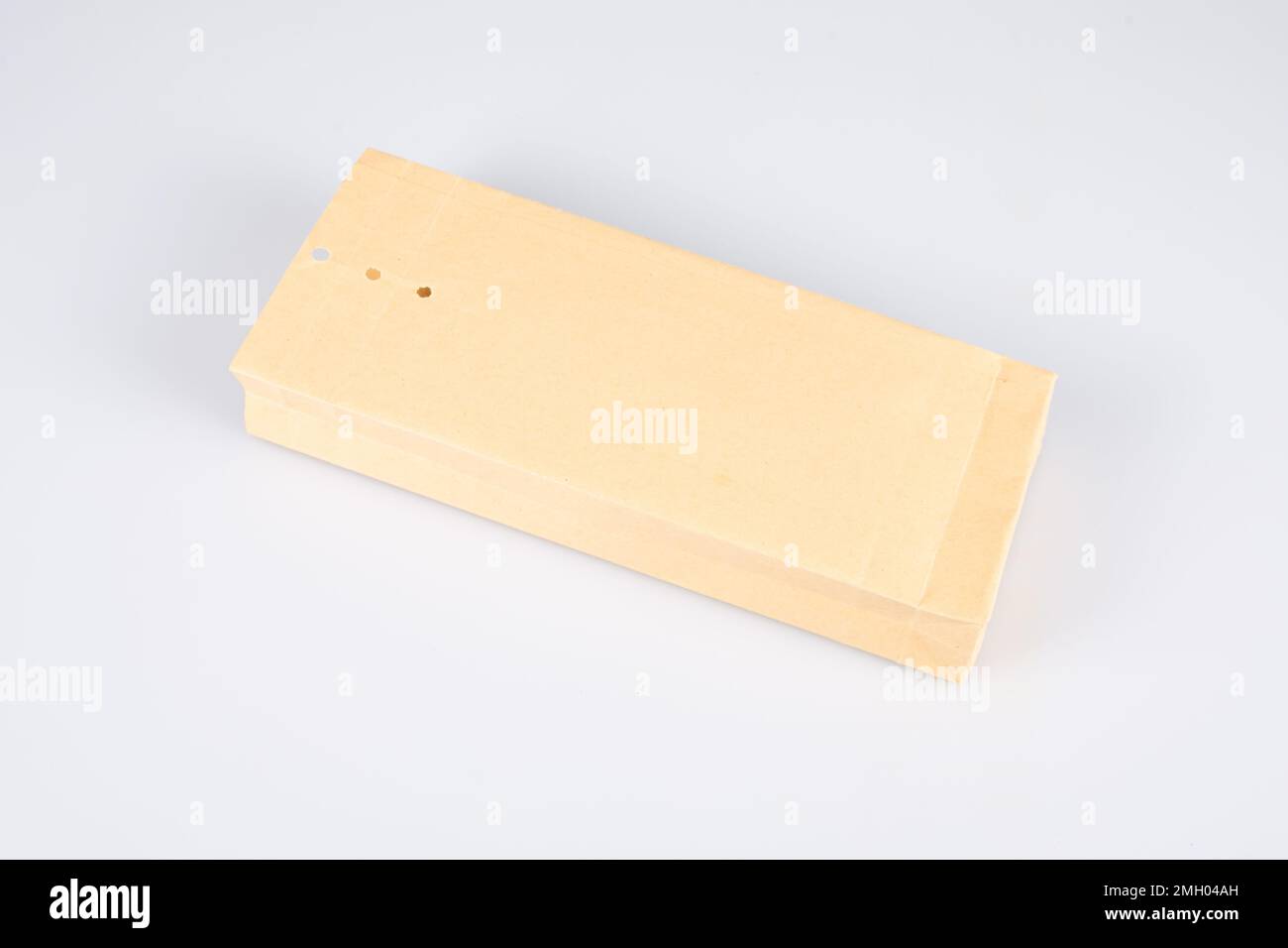 Kraft paper envelope folder perforated closure isolated on white