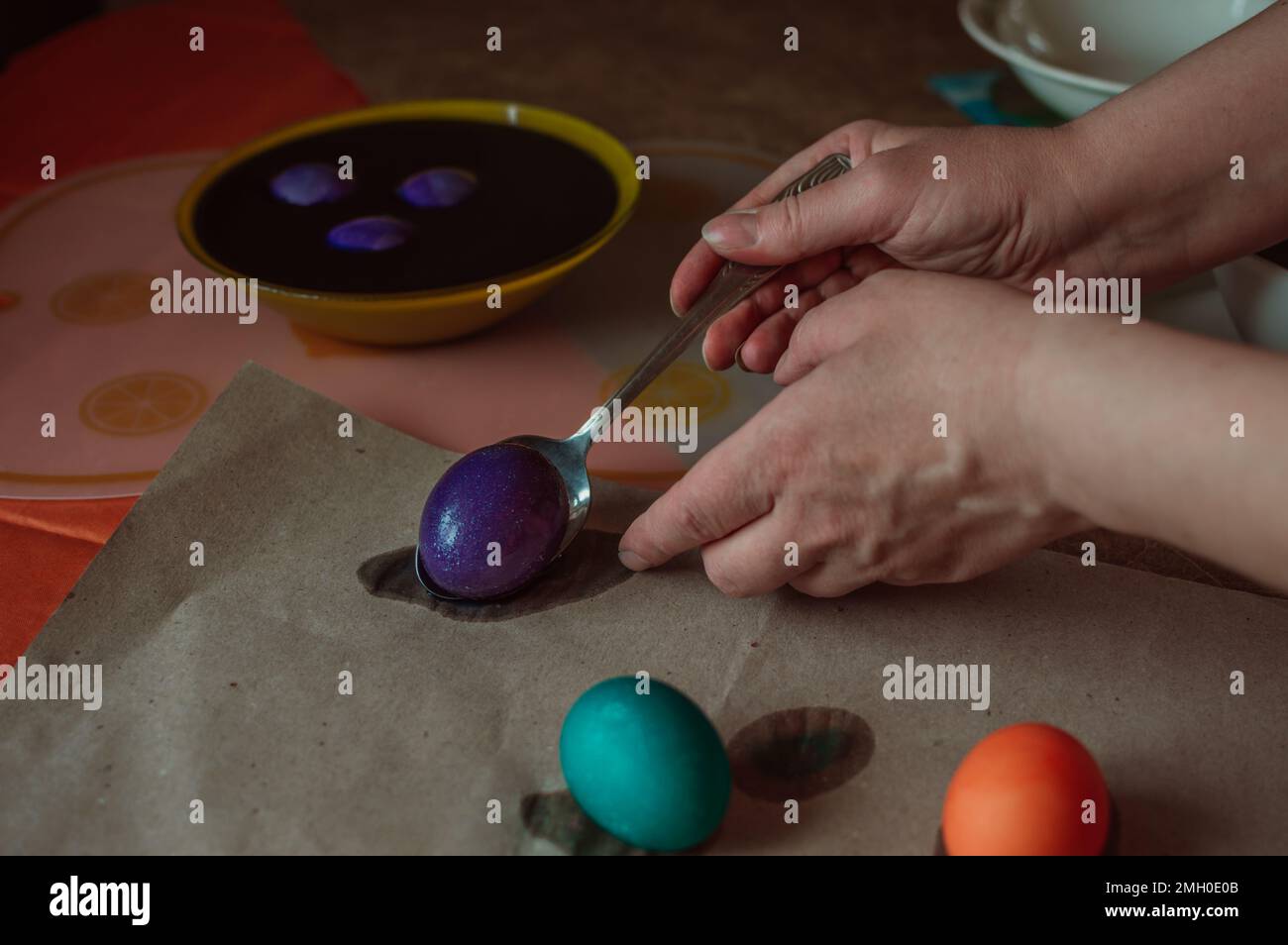 Woman paints Easter eggs for spring holiday Stock Photo