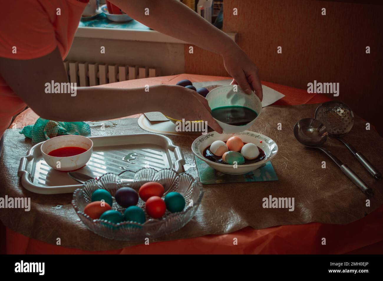 Woman paints Easter eggs for spring holiday Stock Photo