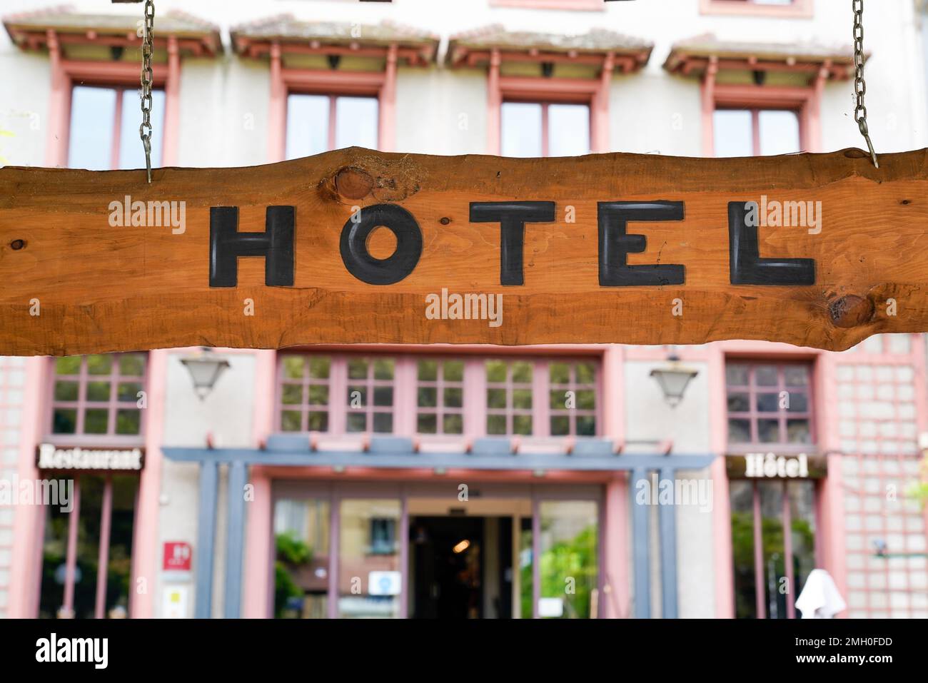 Hotel sign text on wooden entrance on old panel in tourist city Stock ...