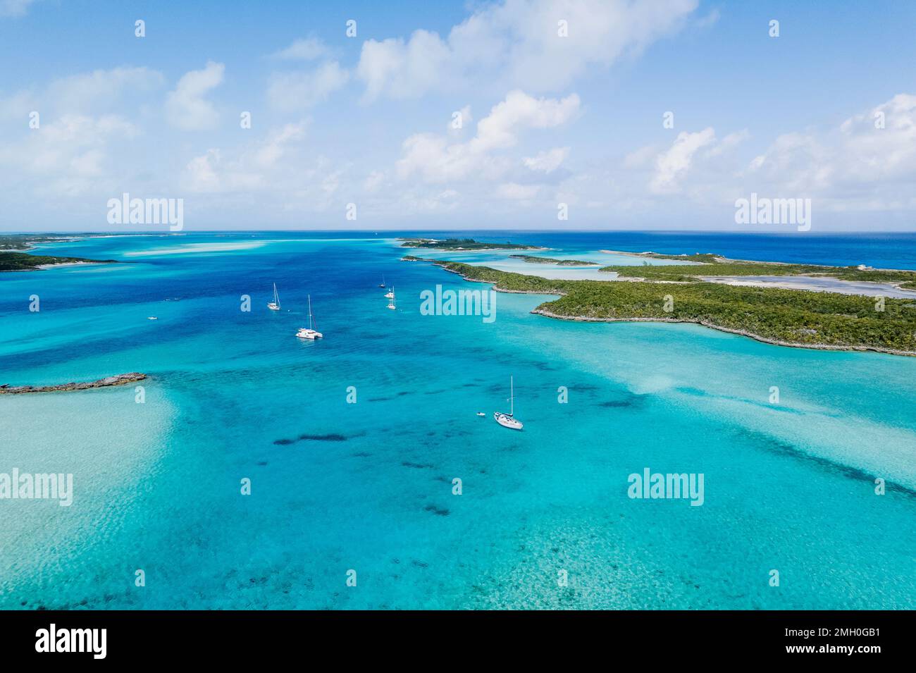 Aerial of Sailboats Anchored in Turquoise Water Between Islands Stock Photo
