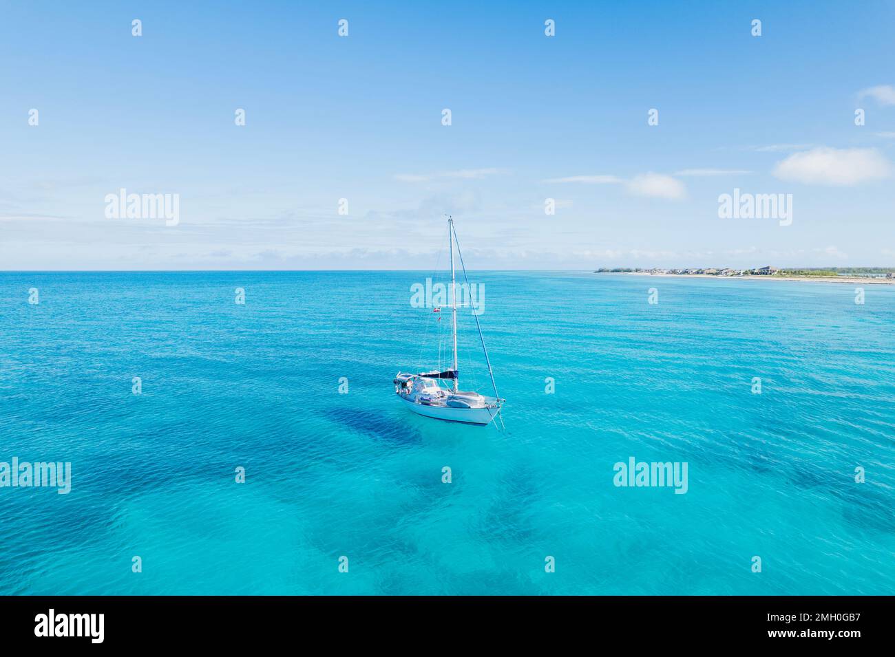 Aerial of Sailboat Anchored in Turquoise Blue Water in Bimini, Bahamas Stock Photo