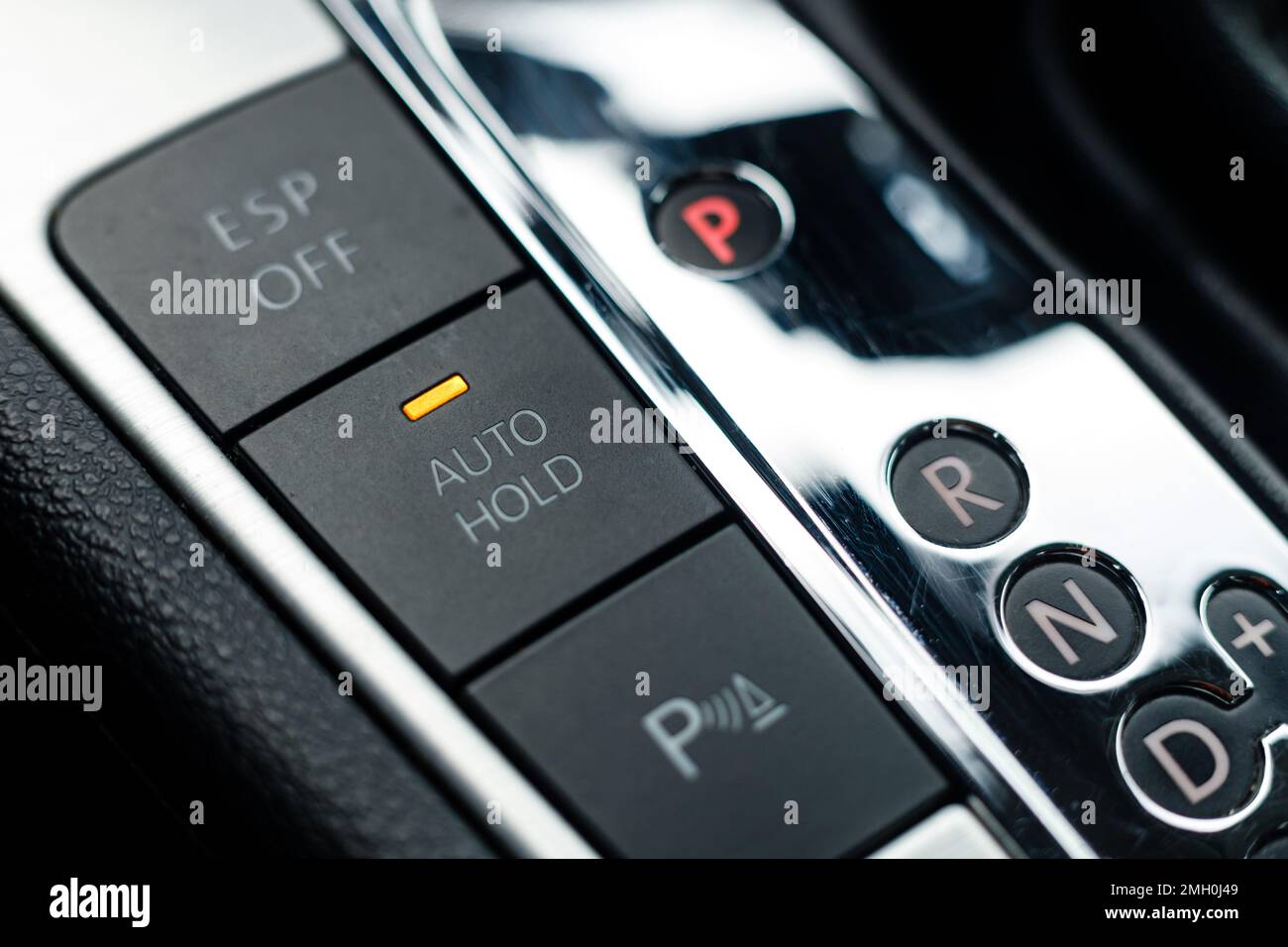 Auto hold button in a modern vehicle turned on Stock Photo