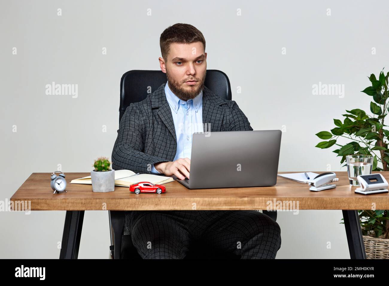man sitting on chair at table and resting, using laptop Stock Photo