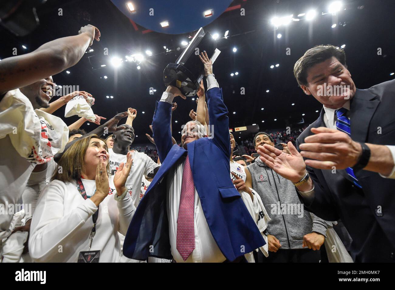 San Diego State head coach Brian Dutcher holds up the Mountain West