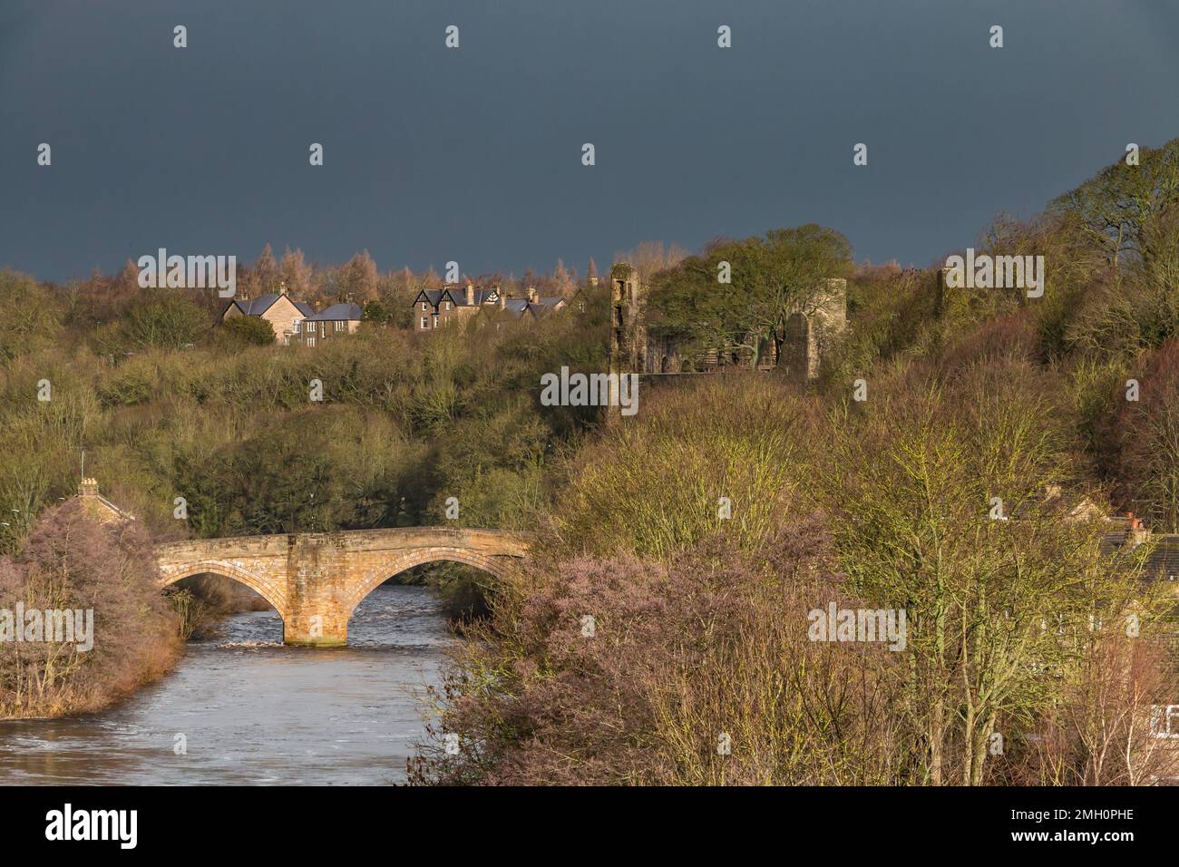 The County Bridge and castle ruins, Barnard Castle, in dramatic light during an extremely brief burst of strong sunshine on a day of heavy showers Stock Photo