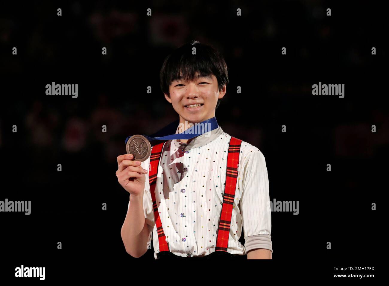 Japan's Yuma Kagiyama poses with his medal during the medal ceremony