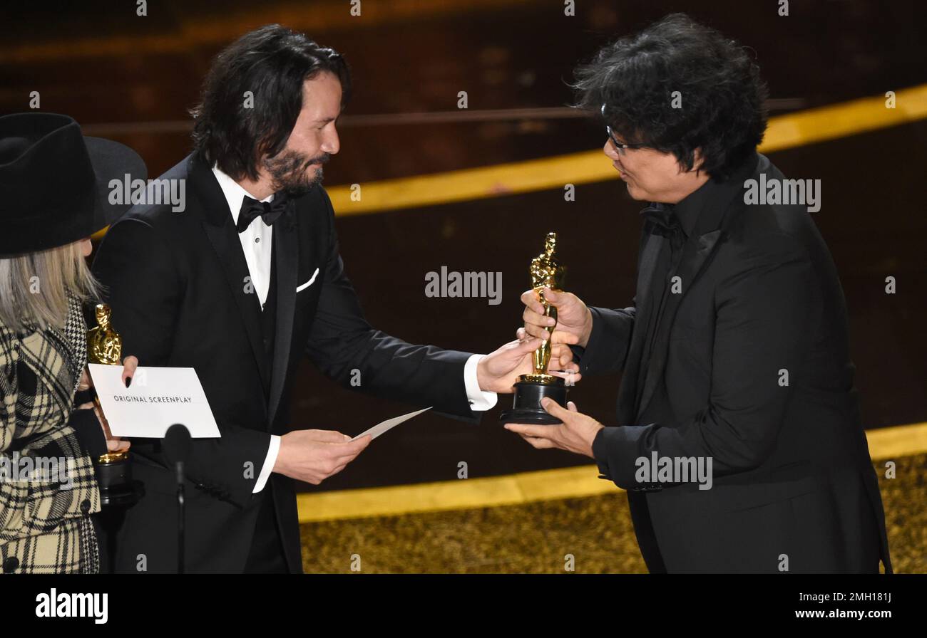 Diane Keaton, from left, and Keanu Reeves present the award for best