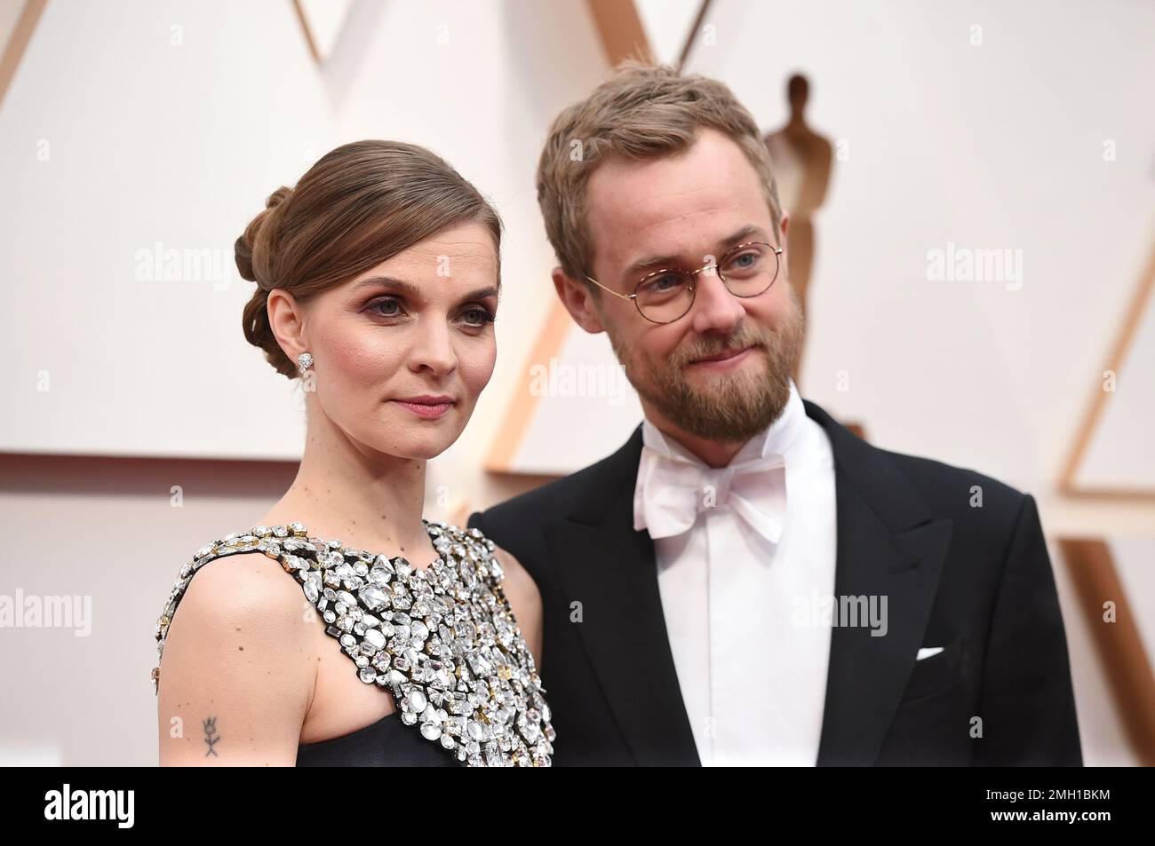 Hildur Guðnadóttir, left, and Sam Slater arrive at the Oscars on Sunday, Feb. 9, 2020, at the Dolby Theatre in Los Angeles. (Photo by Jordan Strauss/Invision/AP) Stock Photo