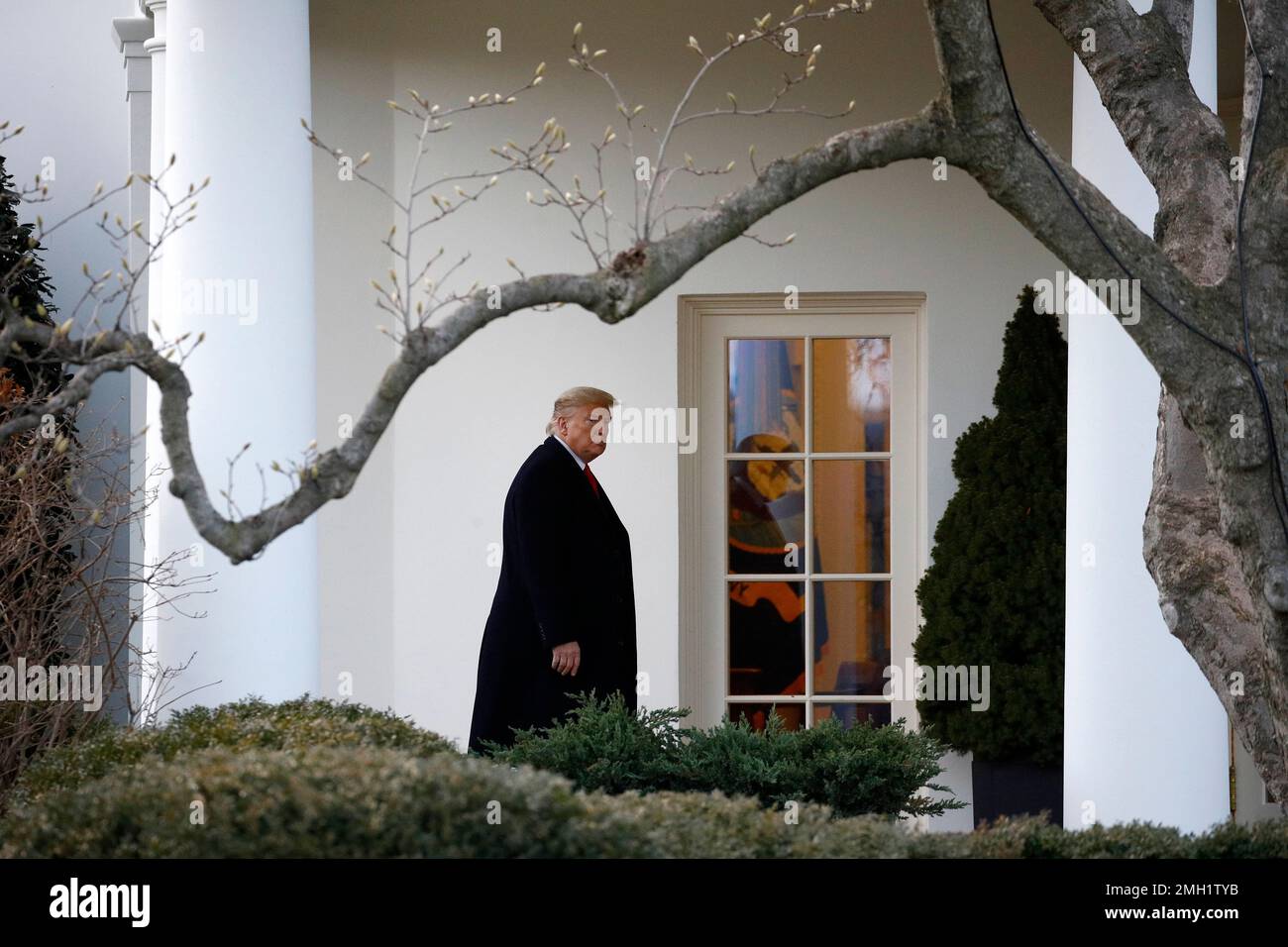 President Donald Trump walks to the Oval Office of the White House in ...