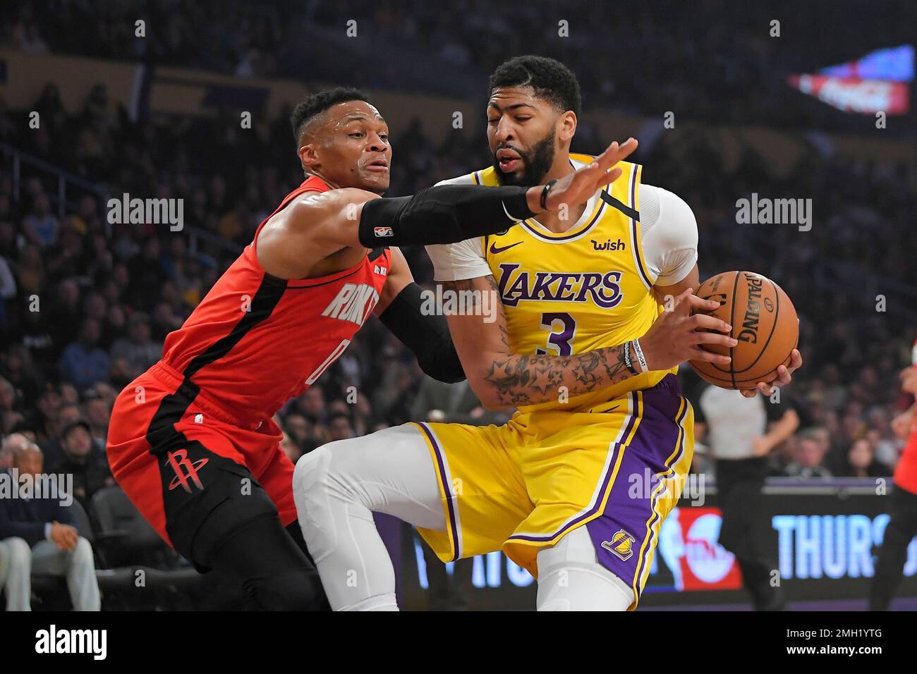 Houston Rockets guard Russell Westbrook, left, reaches for the ball held by Los Angeles Lakers forward Anthony Davis during the first half of an NBA basketball game Thursday, Feb. 6, 2020, in Los Angeles. (AP Photo/Mark J. Terrill) Stock Photo