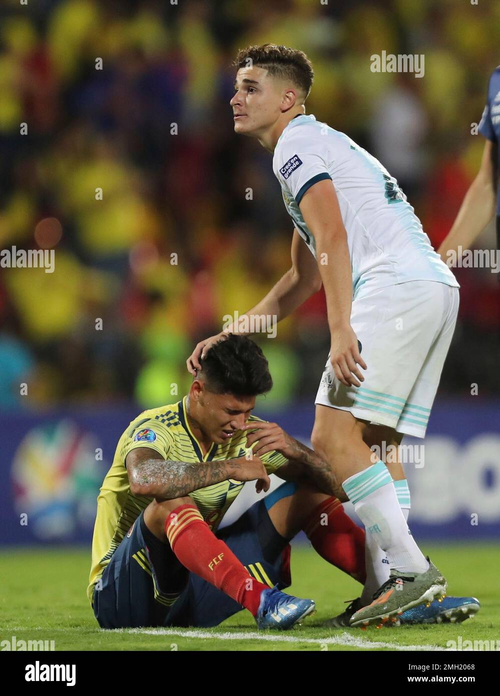 Argentina's Julian Alvarez, right, comforts Colombia's Jorge Carrascal ...