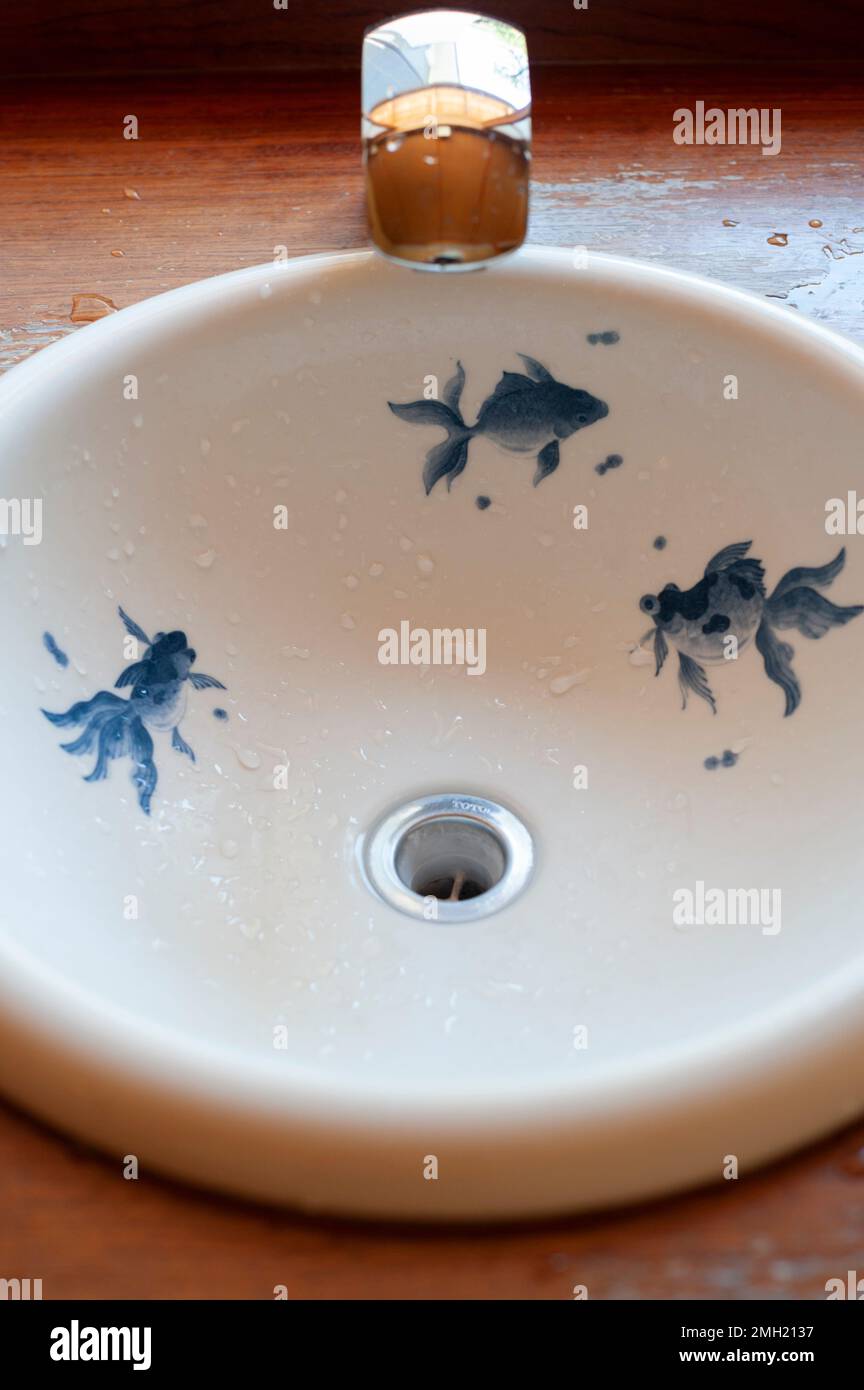A bathroom sink at Kenninji Temple is decorated with blue goldfish ...