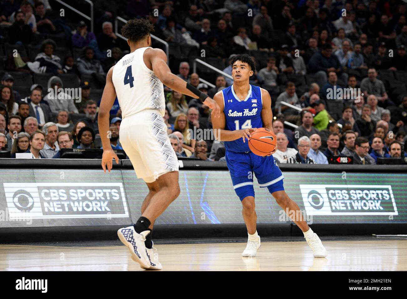 Seton Hall guard Jared Rhoden (14) handles the ball against Georgetown guard Jagan Mosely (4) during the first half of an NCAA college basketball game, Wednesday, Feb. 5, 2020, in Washington. (AP Photo/Nick Wass) Stock Photo