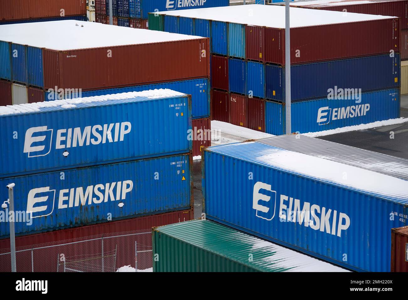 Stacked shipping containers await loading to trucks at the
