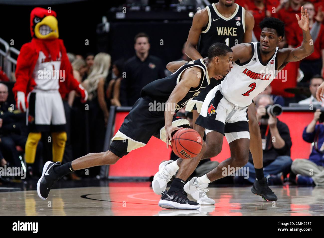 Louisville guard Darius Perry (2) defends as Wake Forest guard Torry Johnson (11) drives to the basket during the second half of an NCAA college basketball game Wednesday, Feb. 5, 2020, in Louisville, Ky. Louisville won 86-76. (AP Photo/Wade Payne) Stock Photo