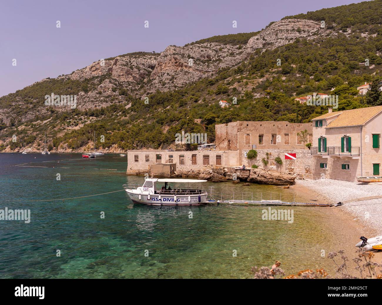 KOMIZA, CROATIA, EUROPE - Dive boat docked in harbor, coastal town of Komiza, on the island of Vis, in the Adriatic Sea. Stock Photo