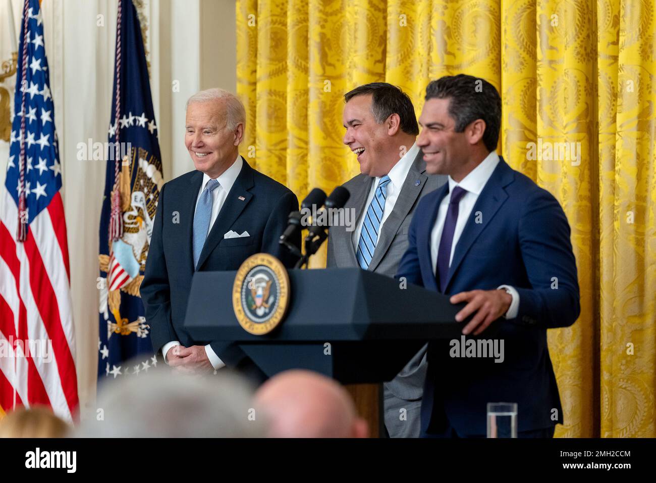 President Joe Biden and Columbus, Ohio Mayor Andrew Ginther look on as