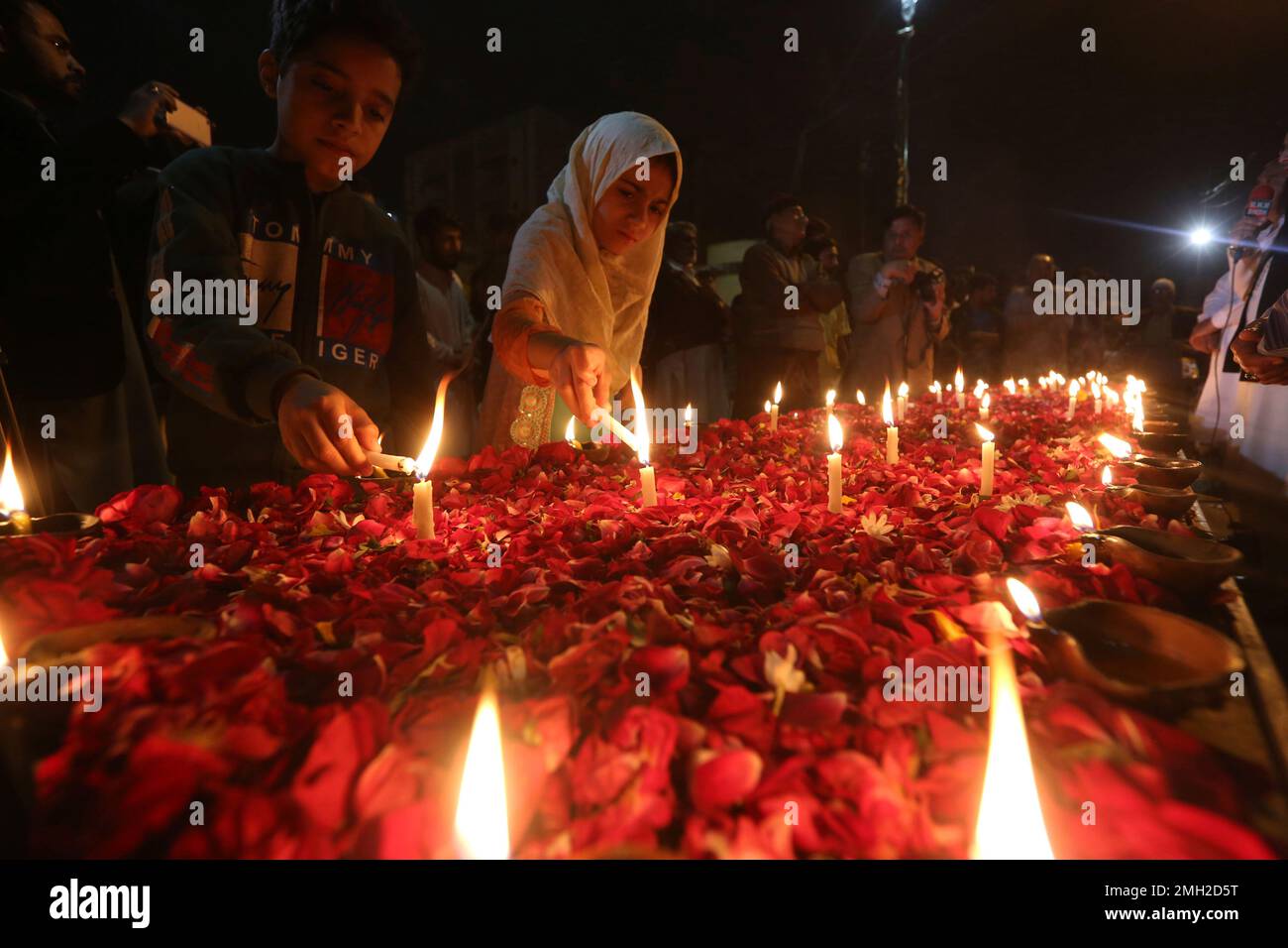 People light candles to express solidarity with Indian Kashmiris in