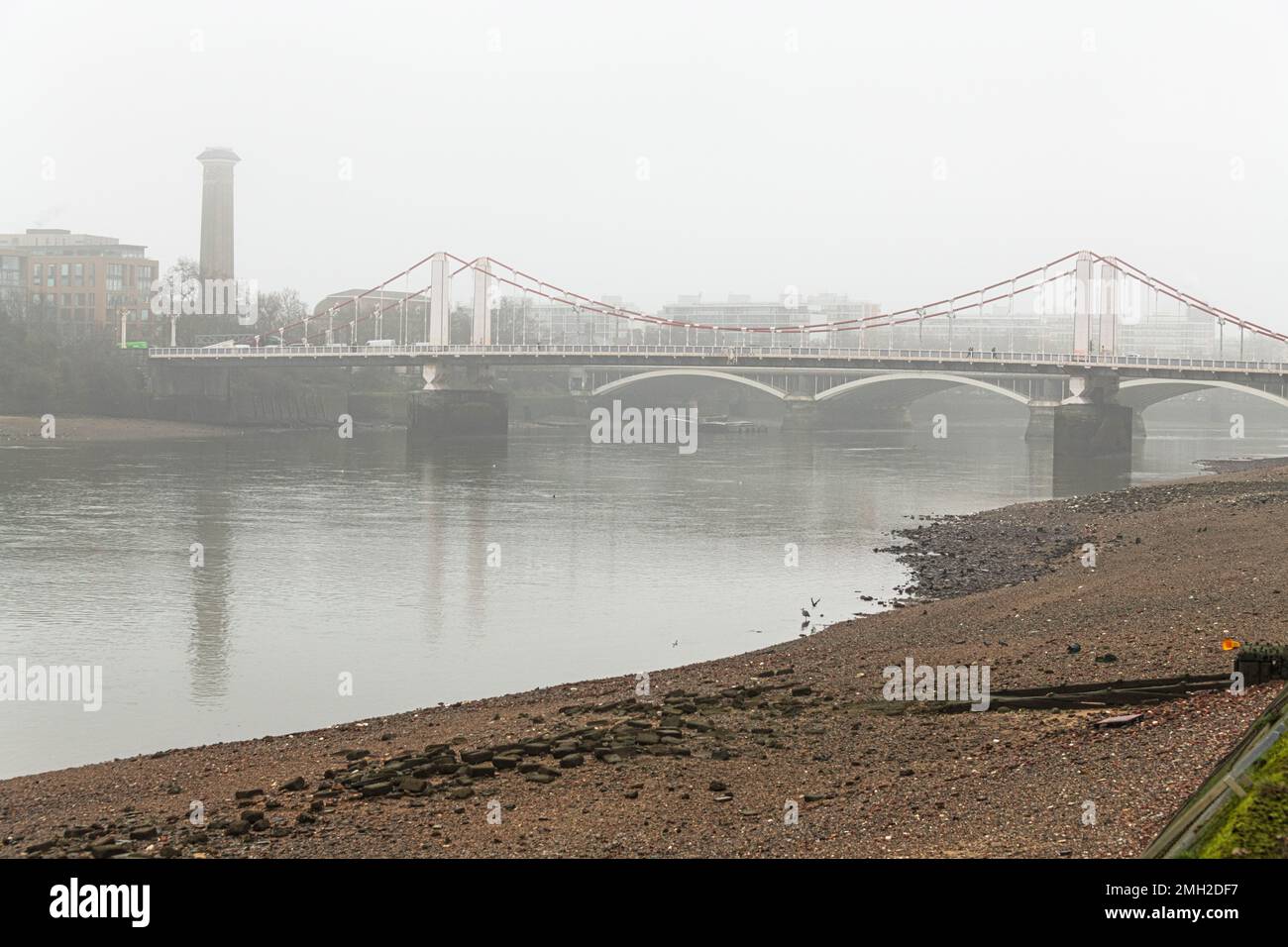 Chelsea Bridge in the fog, taken from the South Bank in Battersea Park. Stock Photo