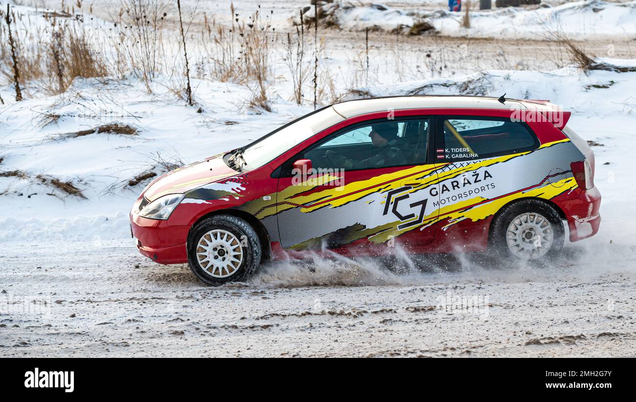 Tukums, Latvia - January. 7. 2023: Young people practice safe driving on a winter track with a sports car Stock Photo