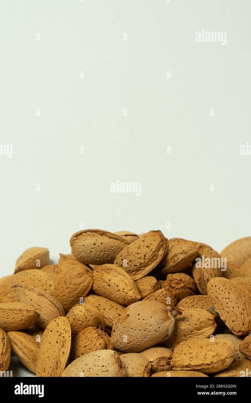 Whole almonds in shell closeup against white background Stock Photo Alamy