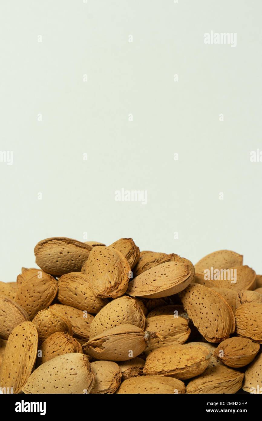 Whole almonds in shell closeup against white background Stock Photo Alamy