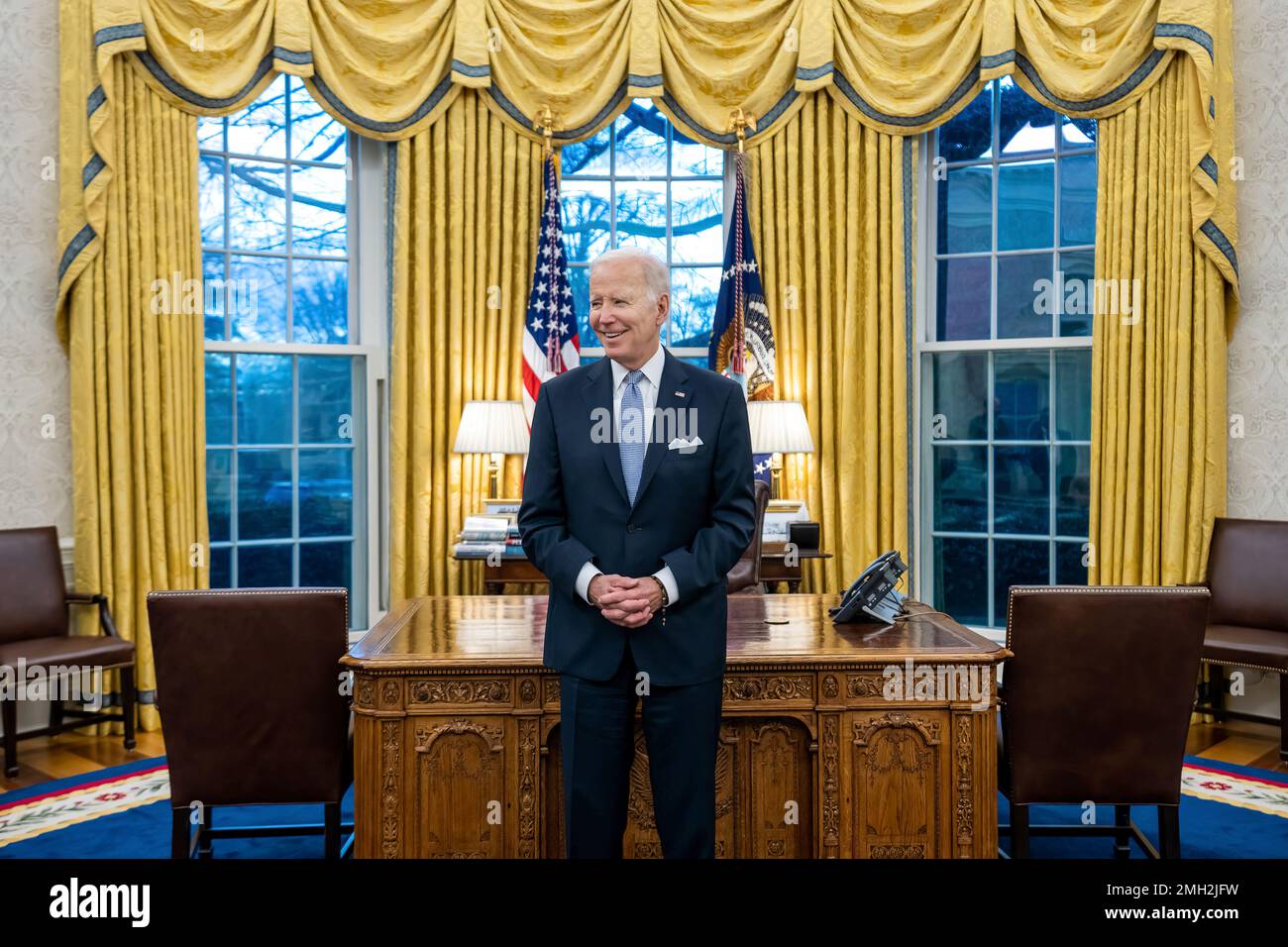 President Joe Biden prepares to greet the family of departing U.S. Army Military Aide Major Bill Yang, Friday, January 20, 2023, in the Oval Office. (Official White House Photo by Cameron Smith) Stock Photo