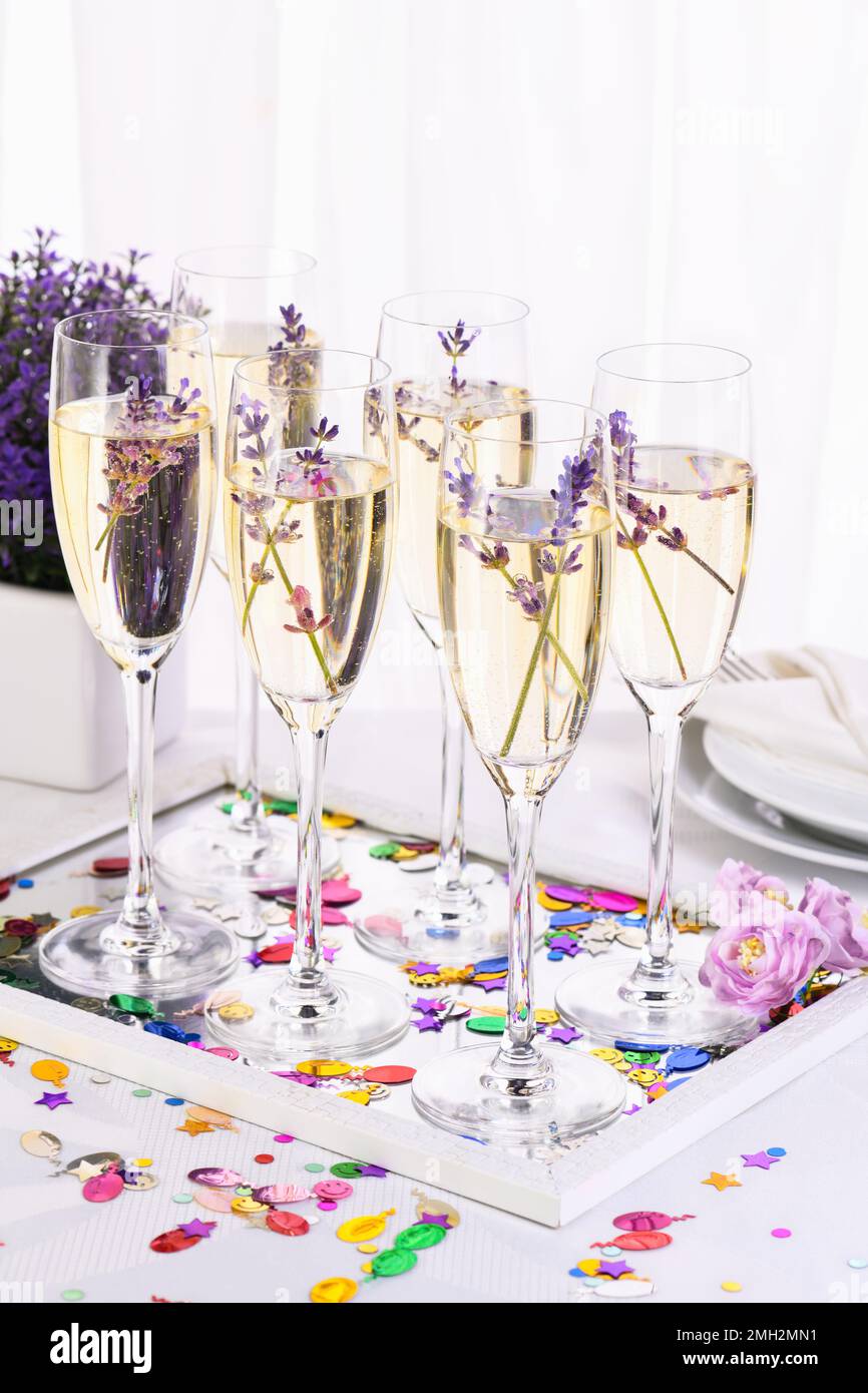 Lavender mood. Champagne with soft gentle notes of lavender. Drink for a wedding dinner. Wedding theme ideas. Stock Photo