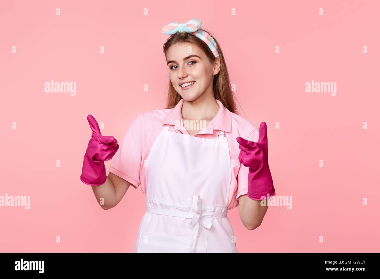 woman in rubber gloves and cleaner apron pointing fingers to camera ...