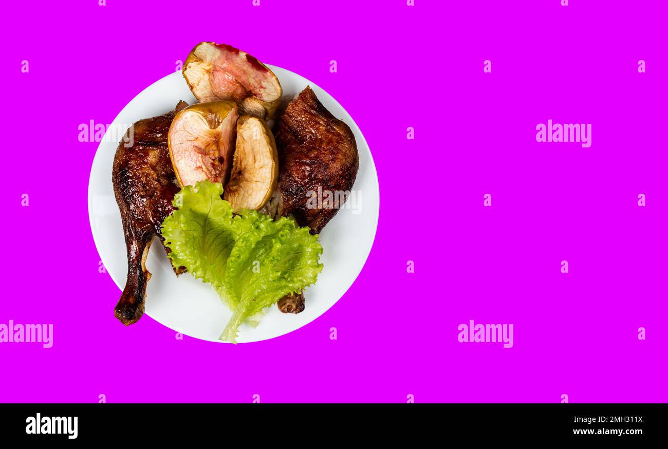 Traditional France dish duck confit with baked apple on isolated background top view copy space Stock Photo