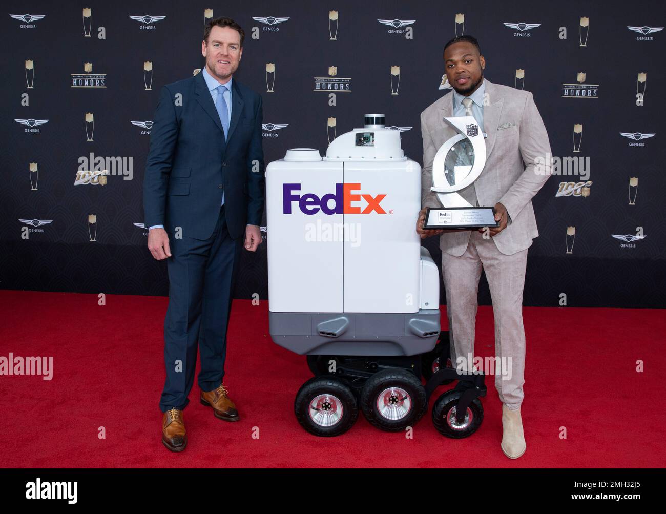 IMAGE DISTRIBUTED FOR FEDEX - Derrick Henry, of the Tennessee Titans,  accepts the 2019 FedEx Ground Player of the Year award from Carson Palmer  at the NFL Honors at the Adrienne Arsht