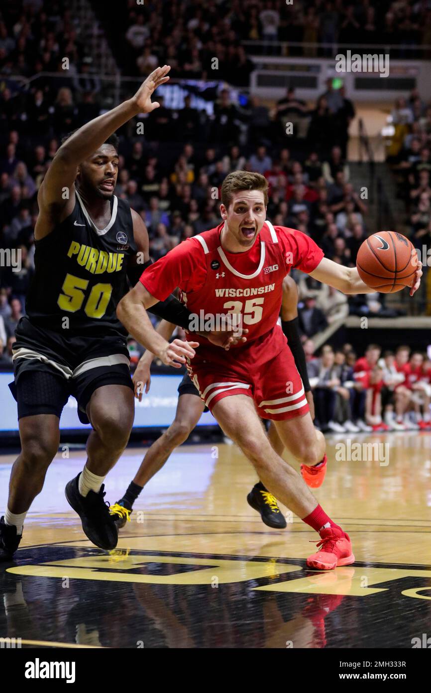 Wisconsin forward Nate Reuvers (35) drives on Purdue forward Trevion ...