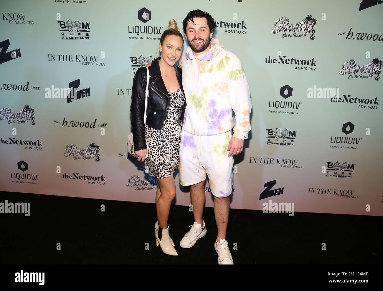 NFL player Baker Mayfield right and wife Emily Mayfield attend the