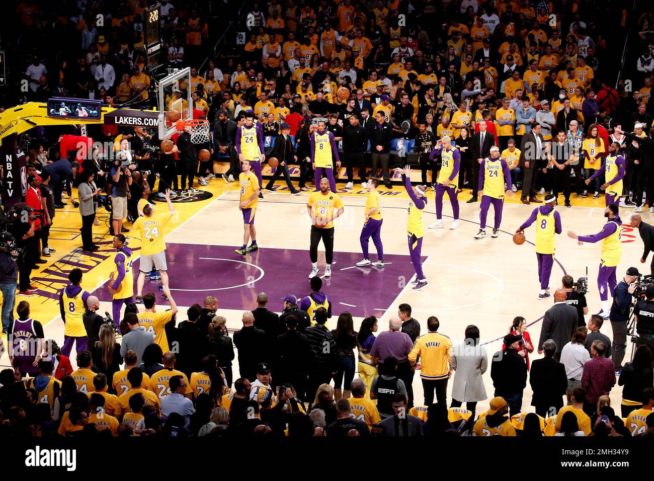 Los Angeles Lakers players wearing No. 24 and No. 8 jerseys in remembrance  of the late Kobe Bryant prior to an NBA game against the Portland Trail  Blazers at Staples Center Friday