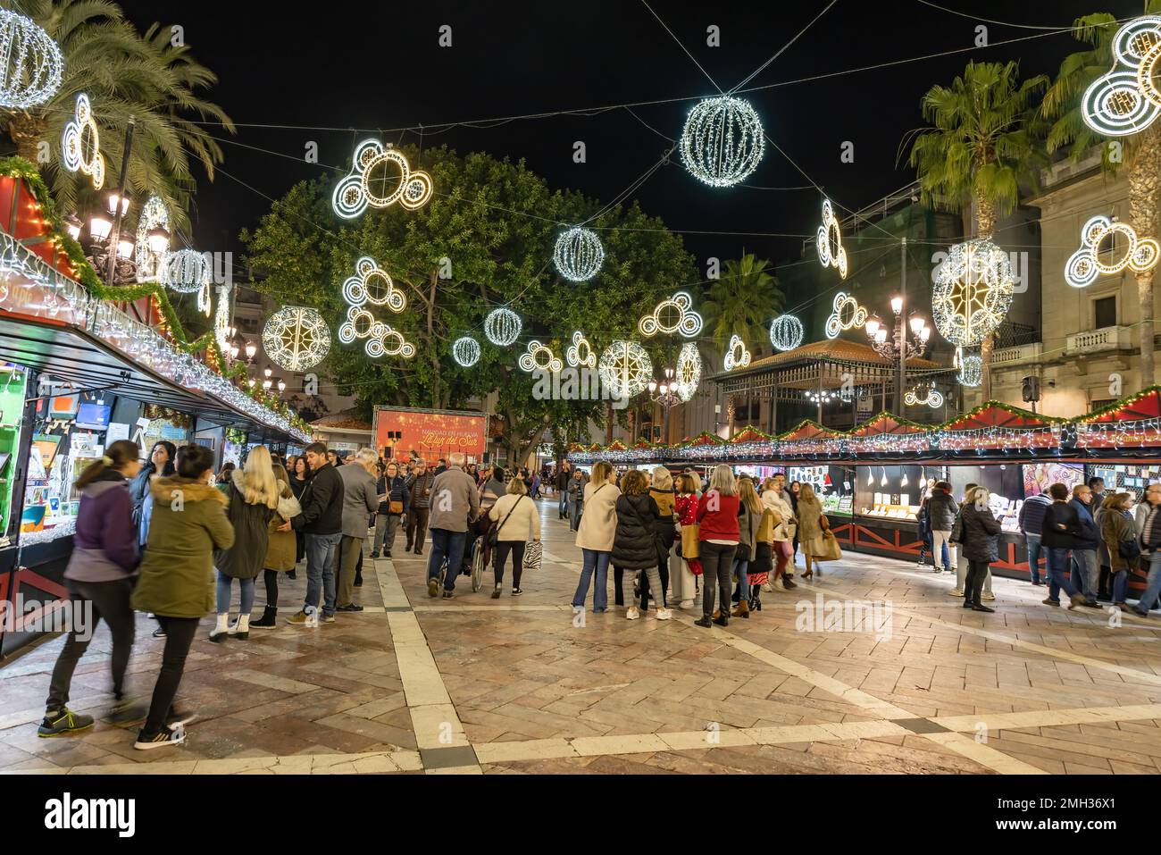Huelva, Spain - December 27, 2022: Crowd of people visiting the the Christmas markets in the Plaza de las Monjas square, in the city center of Huelva, Stock Photo