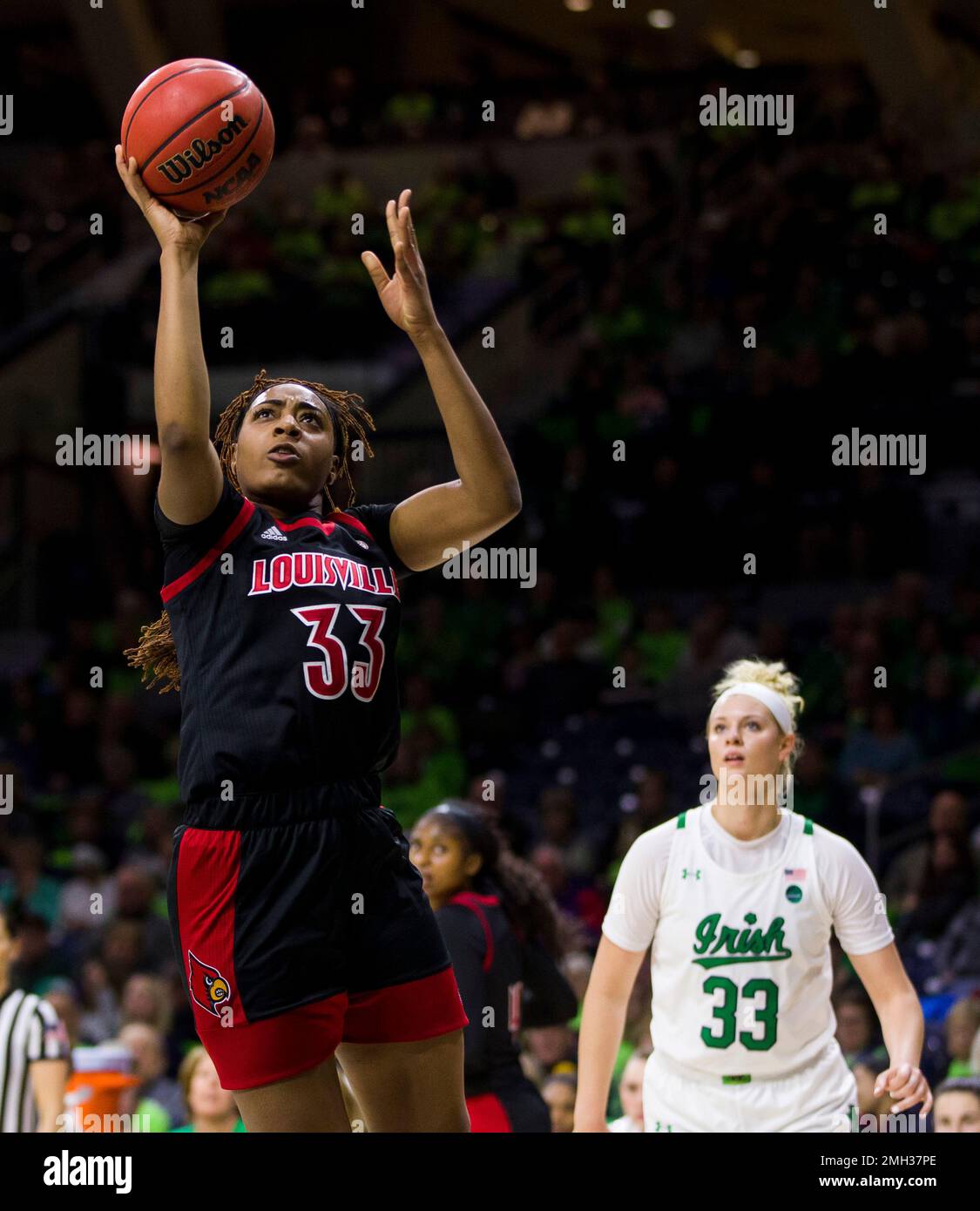 Louisville's Bionca Dunham, left, goes up for a shot in front of Notre