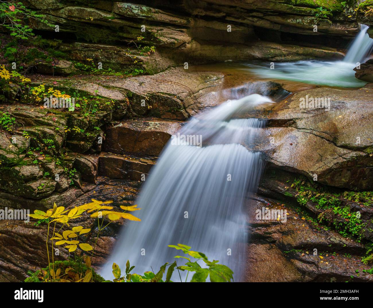 Sabbaday Falls is a beautiful waterfall located in a forest in the White Mountains of New Hampshire. Stock Photo