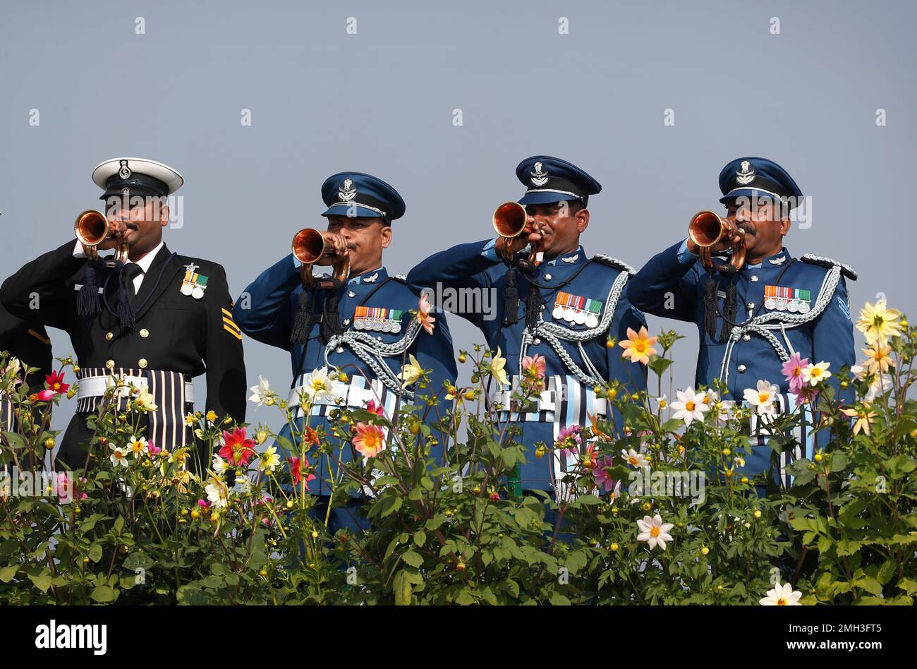 Indian soldiers play the bugle as dignitaries pay their respects to