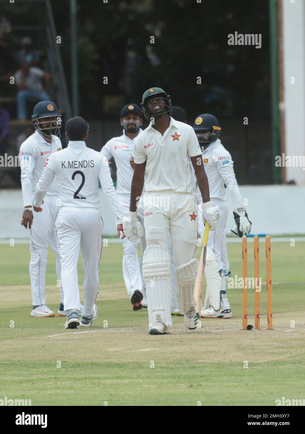 Zimbabwean batsman Tinotenda Mutombodzi reacts after been dismissed